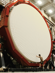 The first of seven mirrors for the Giant Magellan Telescope after removal from the furnace. The back surface of the mirror is shown here during an inspection of the holes used to ventilate the mirror during operation in the telescope. (Photo: Ray Bertram/UA) The first of seven mirrors for the Giant Magellan Telescope after removal from the furnace. The back surface of the mirror is shown here during an inspection of the holes used to ventilate the mirror during operation in the telescope. (Photo: Ray Bertram/UA)
